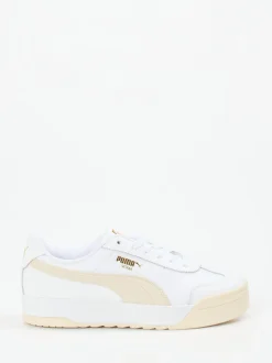 Puma – Sneaker aus Glattleder in Weiß mit Goldakzenten