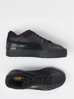 Puma – Sneaker aus Leder in Schwarz mit Goldakzenten